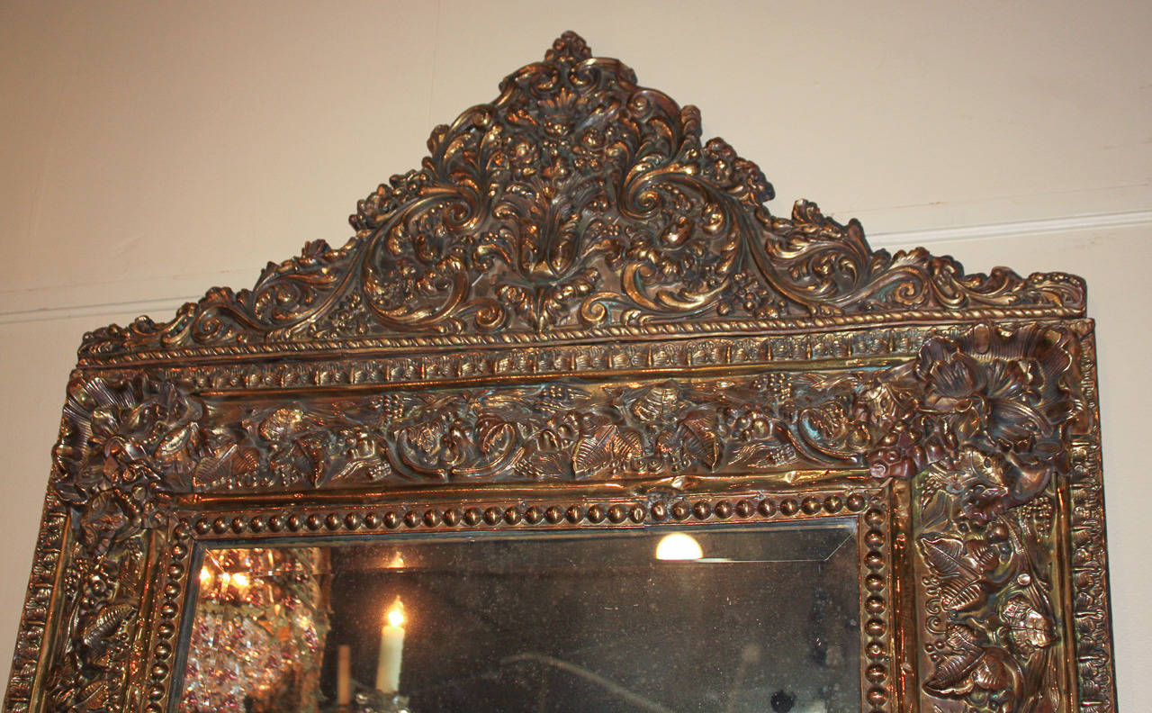 Lovely 19th c. Repousee gilt brass cushion mirror with nicely cast acanthus leaf and fruit motif.  Having impressive detailed cartouche and wonderful finish throughout.  Beyond chic for numerous designs!