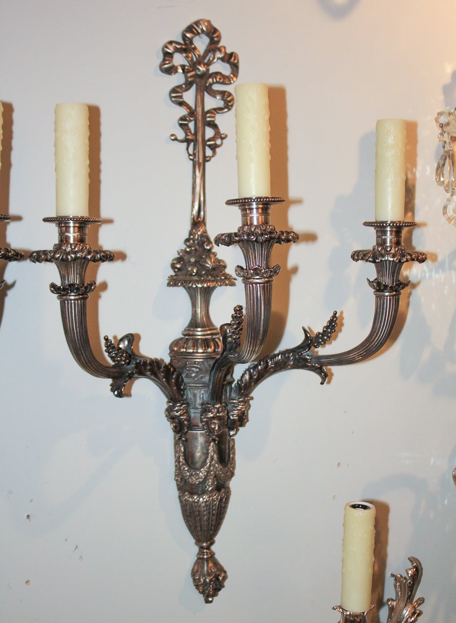 Fantastic pair of French Napoleon III nickel-plated 3-light sconces.  Having fine detailed castings of ribbon, cornucopia, swag, and acanthus motifs.  A great pair of sconces to suit a variety of decorative styles!