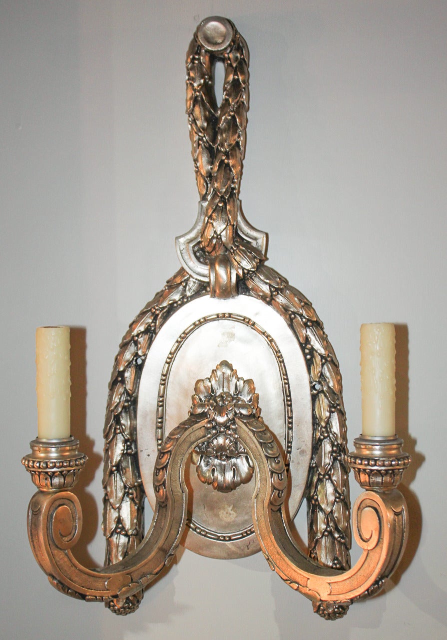 Sensational pair of heavy French silvered bronze 2-light sconces.  Having scroll arms and heavy swag adornment.  Wonderful for numerous designs!