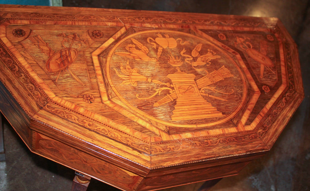 Fabulous neoclassical Italian flip-top games table with detailed inlays. Having elaborate urn, torche, and bird motifs inlaid on to top and apron, and resting on tapered legs. Felt is not original. An attractive piece worthy of any design!