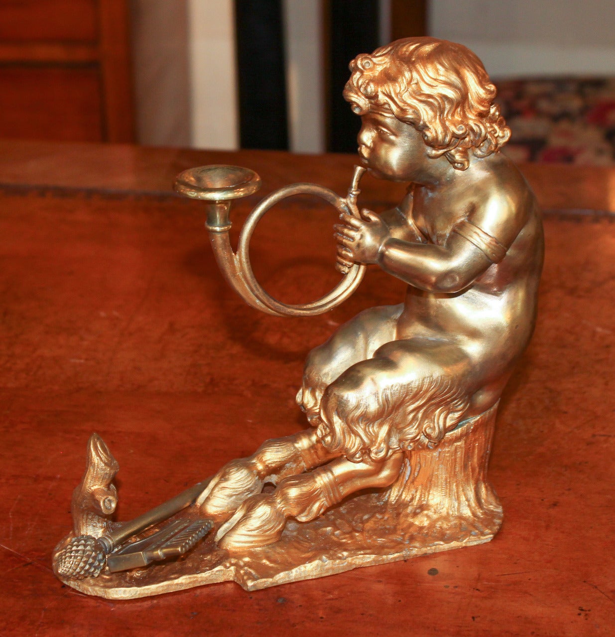 Wonderful pair of French gilt bronze bookends each depicting a seated young centaur playing a horn.  Having nicely detailed casting and lustrous finish.  Absolutely darling and worthy of any design!