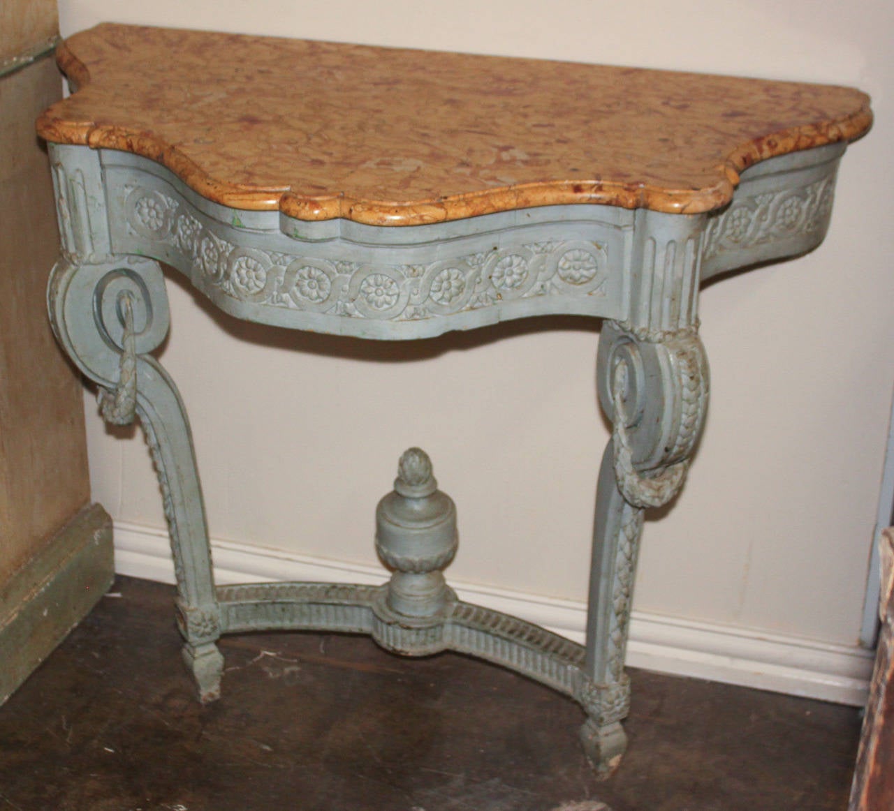 Wonderful French carved wood, painted console and marble top. Having rosette carvings across apron, scrolled knees and swag, and curved stretcher with urn.