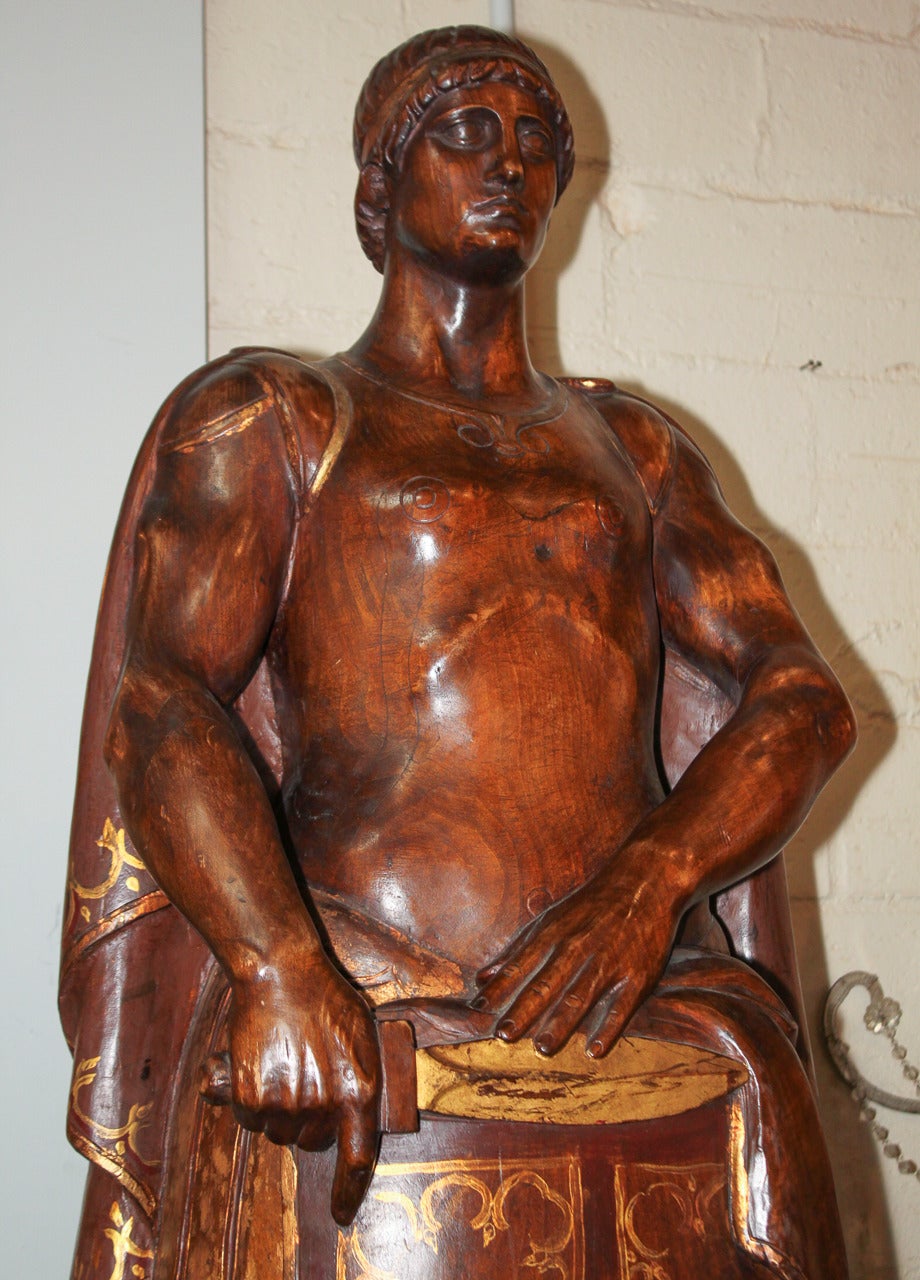 Impressively carved walnut figures of warrior and scholar. Having rich polished patina with gold painted accents and of nice scale and proportion. Scholar has 