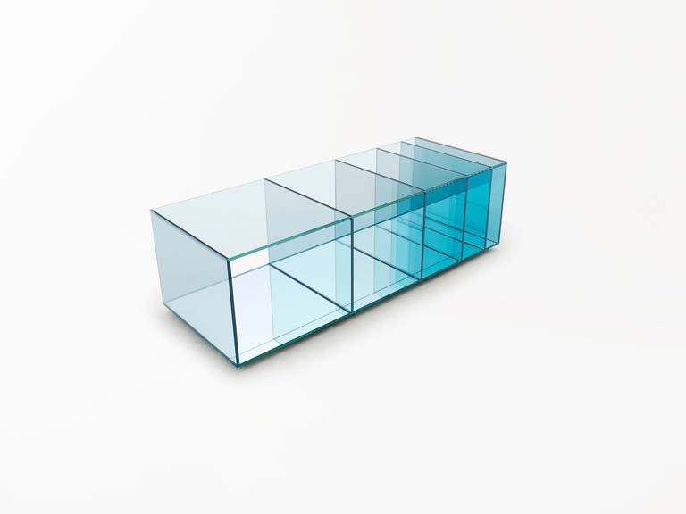 This low table accompanies the bookcase in the Deep Sea collection by Nendo and Glas Italia. Each of its glass sheets has been treated separately and coloured by melting a layer of transparent coloured film onto the surface. 

The vertical