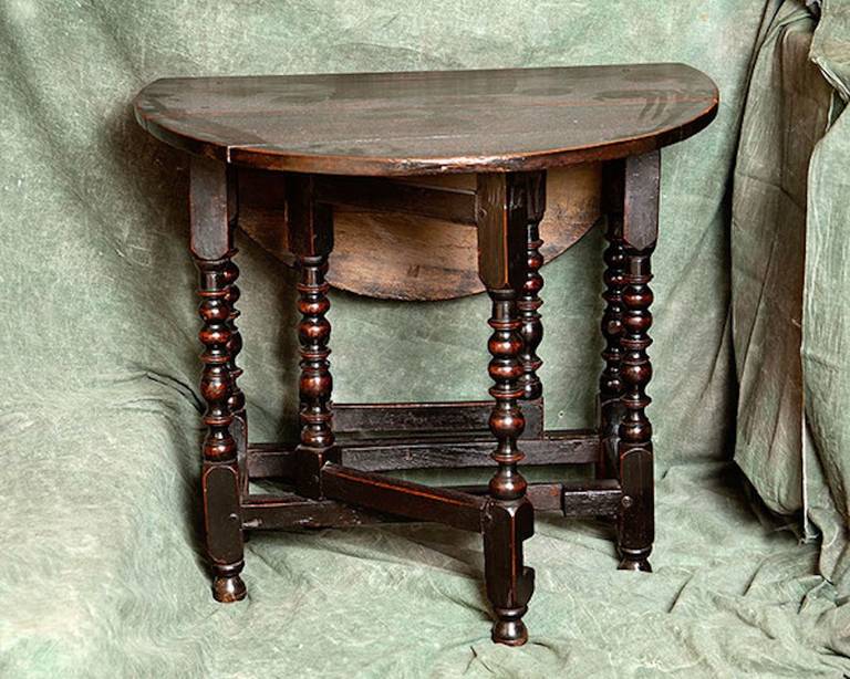 A late 17th Century Oak Gateleg Table of small proportions; excellent colour and in original untouched condition; the owner's initials 'TB' are carved at the top of one of the legs.

English c.1680-1690