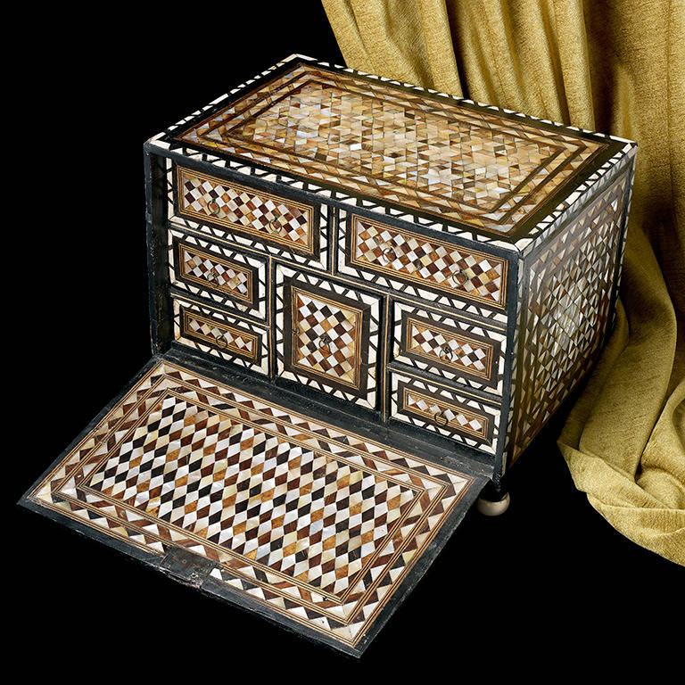 A very rare Ottoman table box, the fall front opens to reveal an arrangement of seven drawers; decorated throughout with differing patterns of tortoise shell and mother-of-pearl; approximately 17 1/2 inches wide, 12 1/2 inches high and 11 1/2 inches