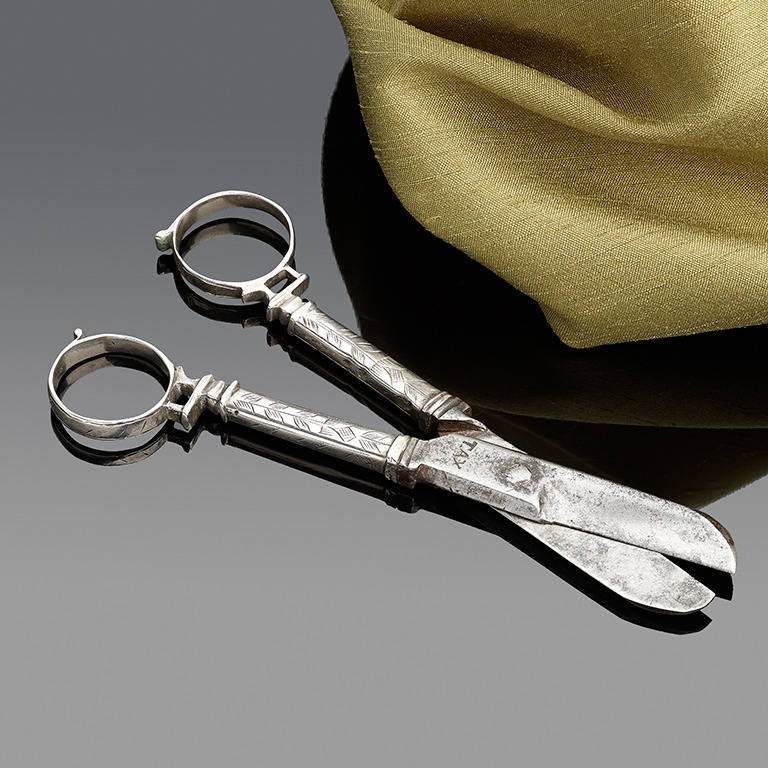 An Extremely rare Charles I Silver Pair of Scissors, circa 1635-1640; one of the earliest recorded pairs of silver scissors of the Albert Collection p.321; the steel blades are stamped 'TAX' on one side and a neat littles maker's mark of a halberd