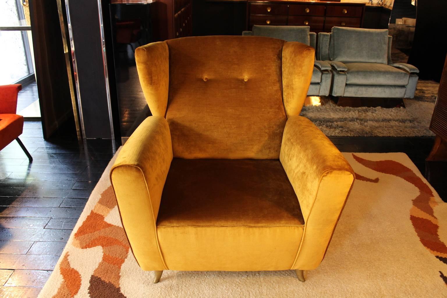 Pair of armchairs contemporary in 1960s style gold velvet and brass fittings.