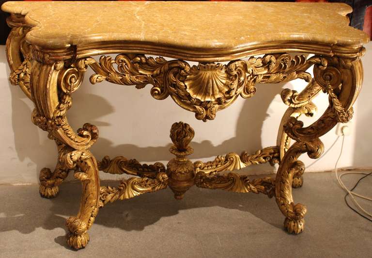 Gilded and carved wood with marble top.