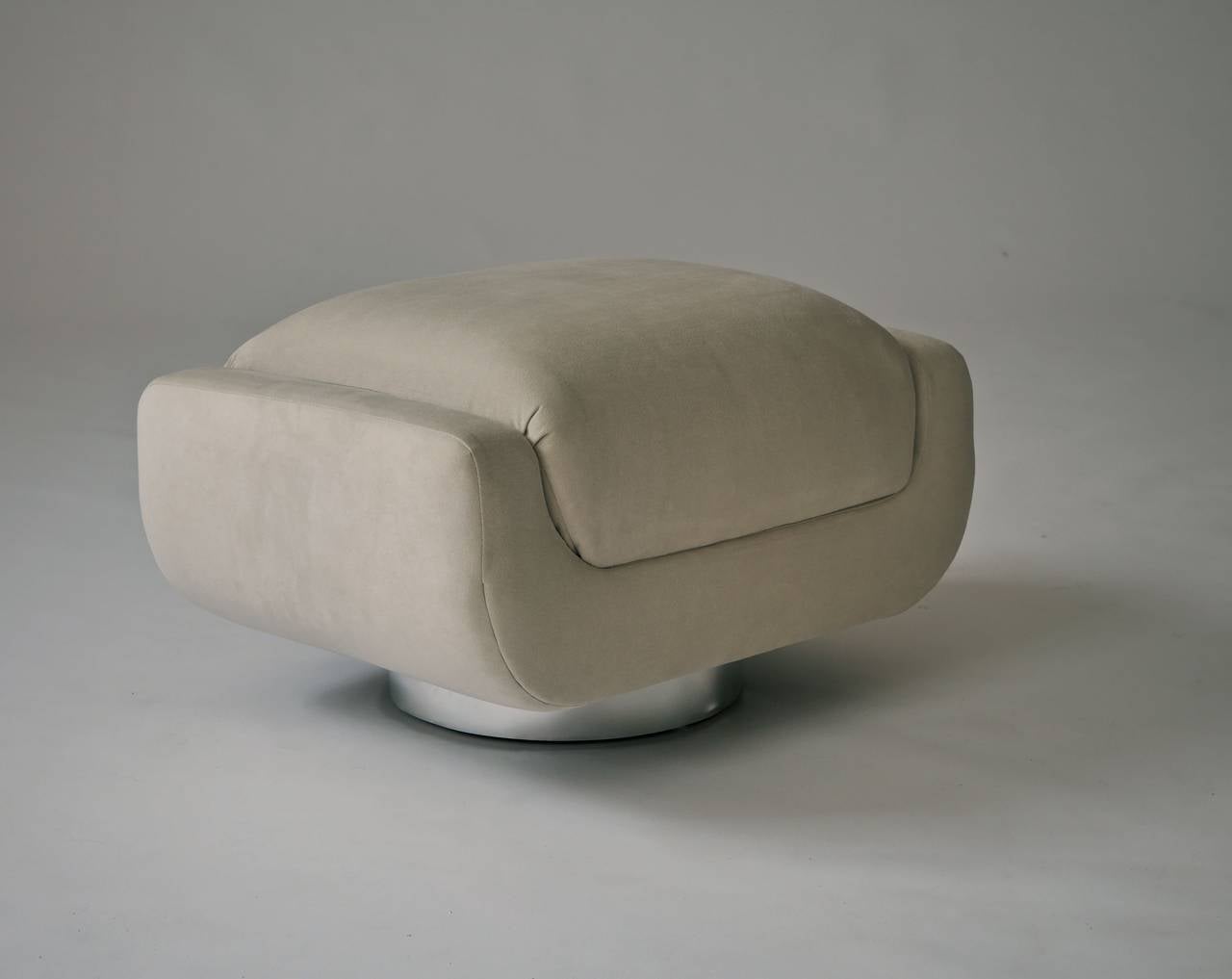 Beautifully reupholstered in bone colored ultrasuede Vladimir Kagan swivel lounge chair and ottoman for Directional.