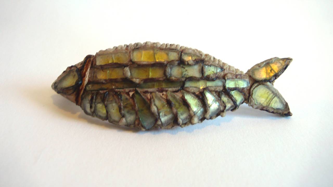 Line Vautrin talosel and yellow colored glass brooch in the shape of a fish.

Signed.