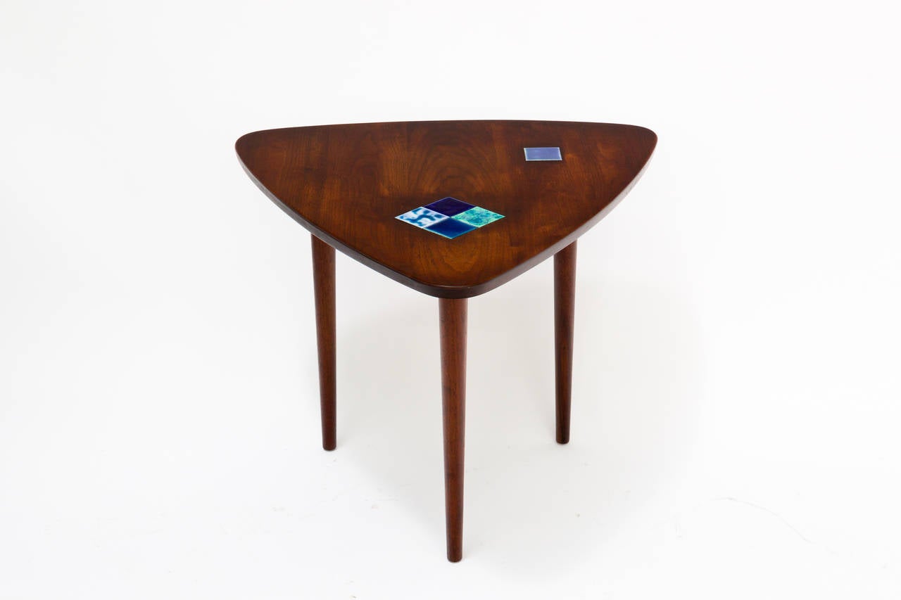 Mid century modern American walnut guitar pick shaped table with ceramic tiles.
