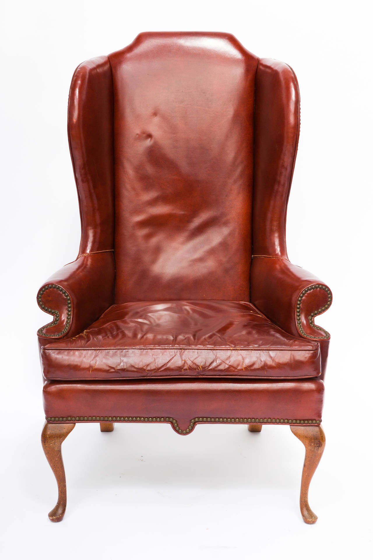 Whimsical leather wing chair with cabriole legs. Great Lines