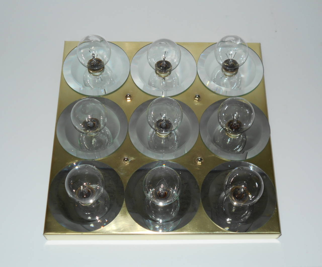 Mid century flush mount 9-light fixture. Solid brass with mirrored panels.