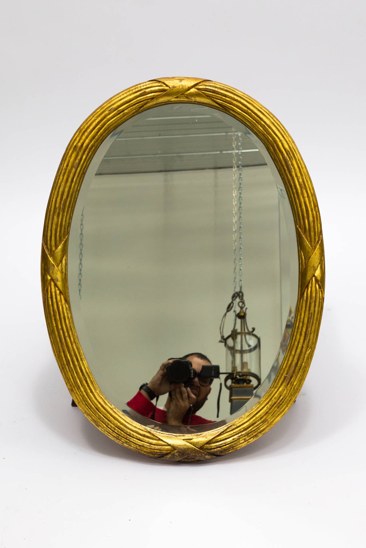 Carved Italian giltwood oval mirror.