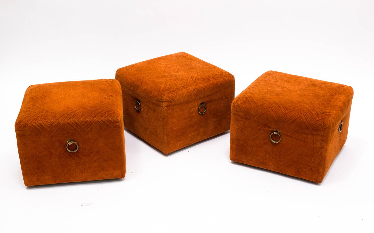 Set of 3 upholstered cube ottomans.