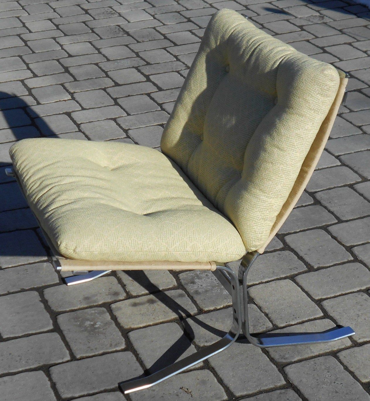 Pair of Italian brushed chrome lounge chairs. They have canvas seat and back support with upholstered cushions.