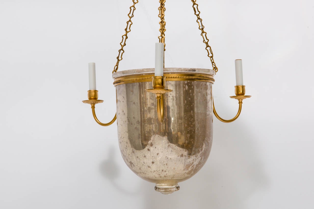Pair of mercury glass bell jar pendant, with embossed brass details.
Made to order. Sold individually.
Antique silver finish on glass may present variations due to the handmade process.