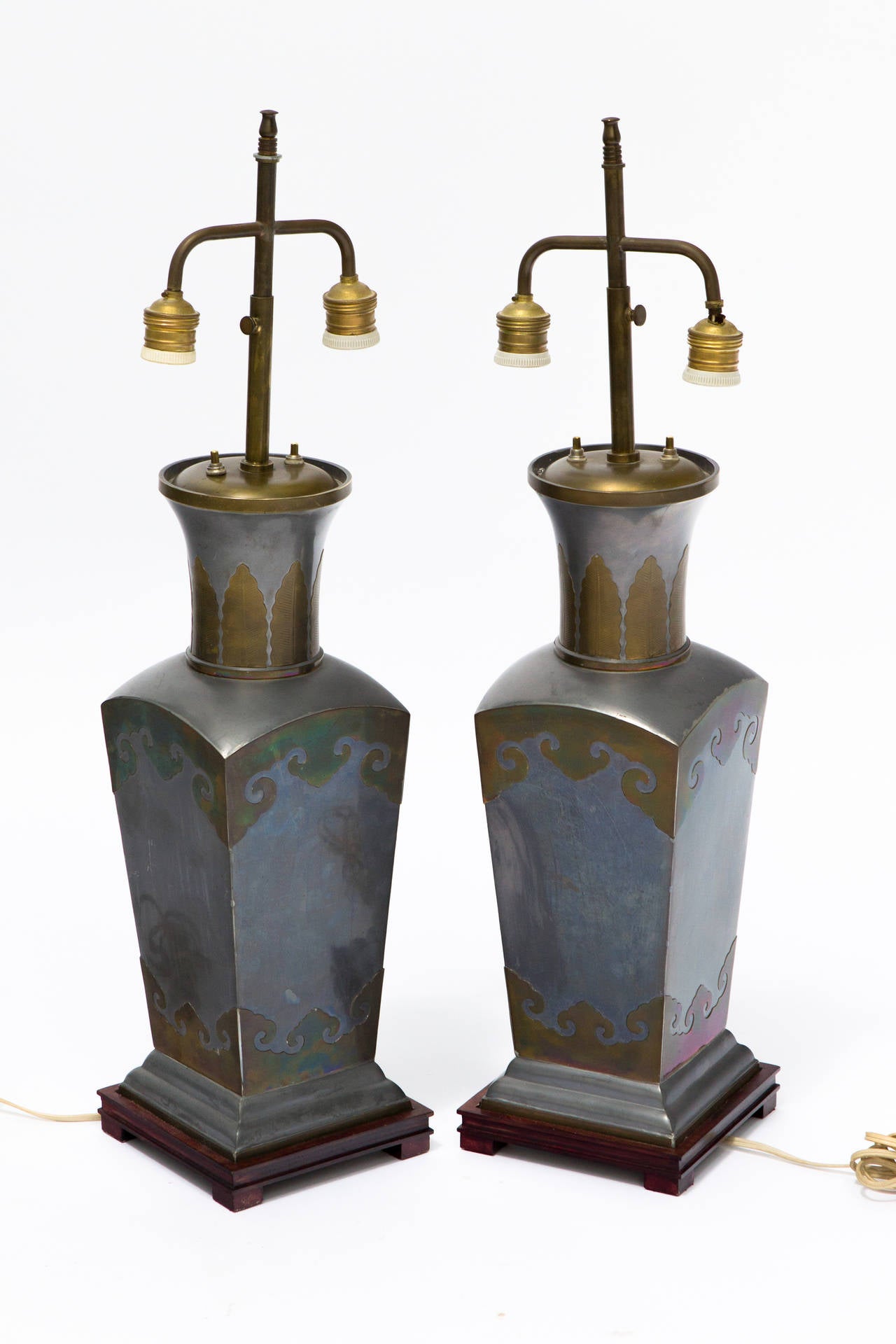 Pair of Asian Pewter and Brass Accented Lamps

Height is measured from the base to the top of the vase.
