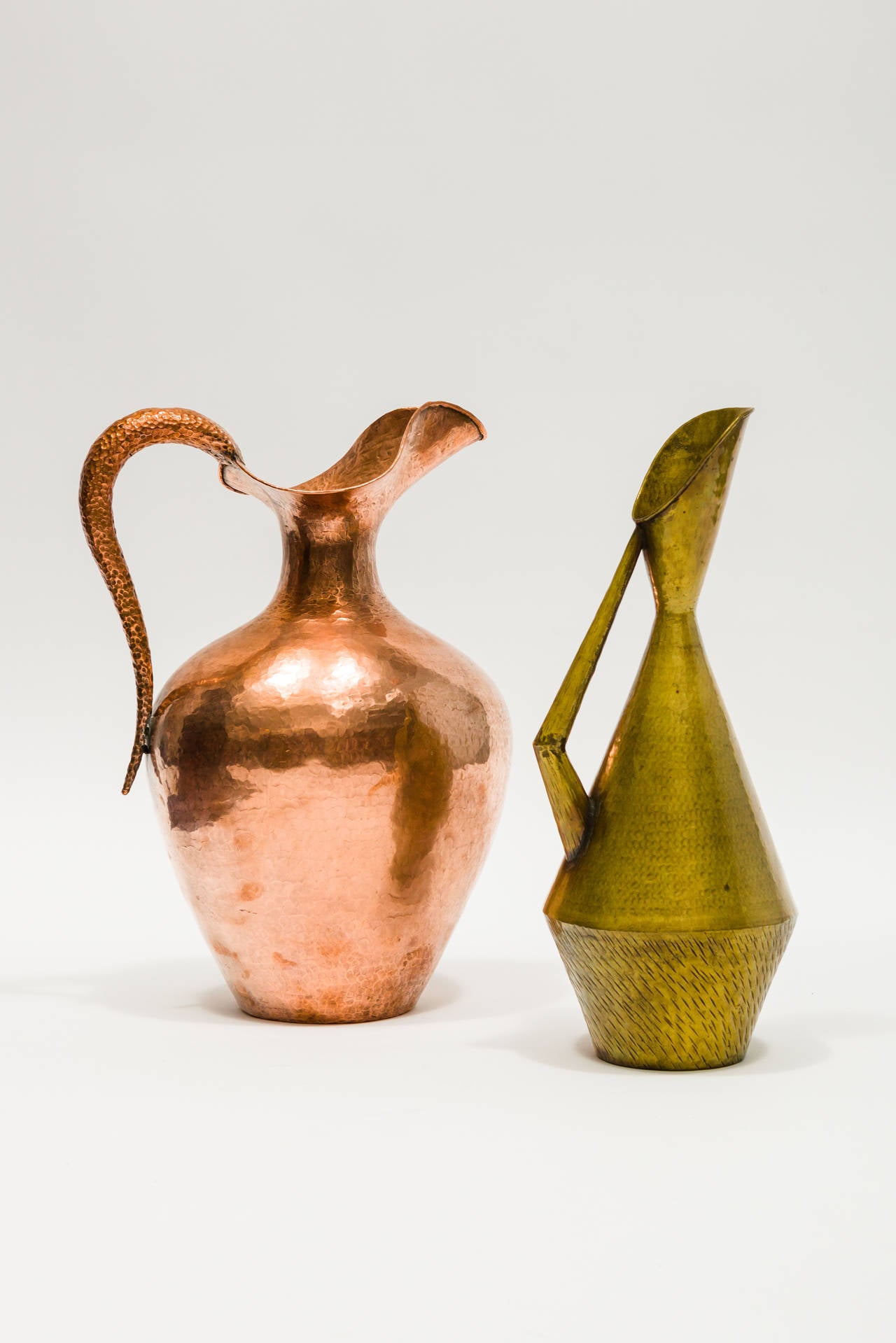 These hand hammered brass water pitcher from the early to mid 20th century were designed and formed by Egidio Casagrande in Italy.They have the Casagrande Borgo Trento Italia stamp on the bottom.
Priced for the pair.
Brass pitcher: 5.5