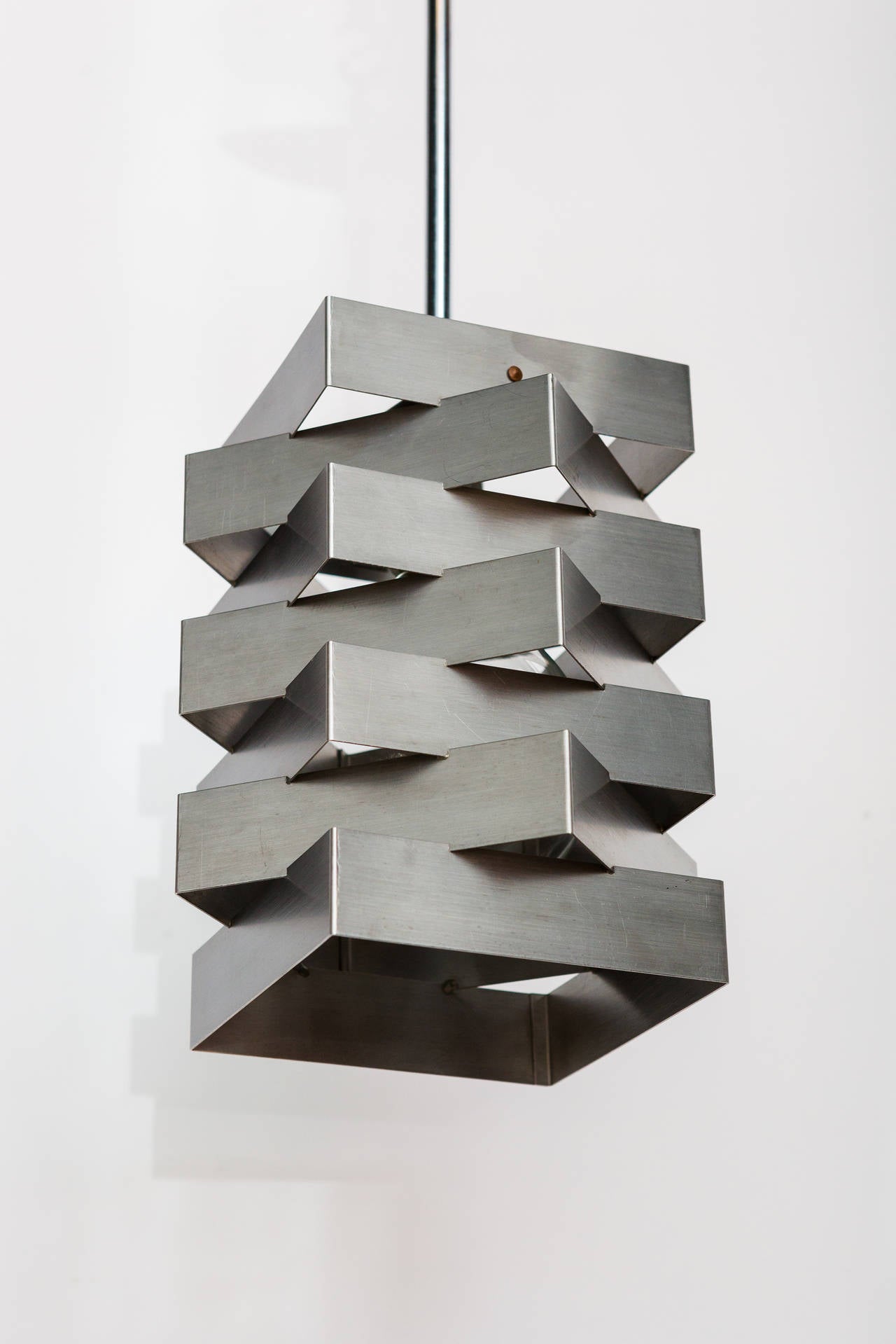 A geometric pendant comprised of stacked and intersecting squares of steel. As shown they measure 23.5