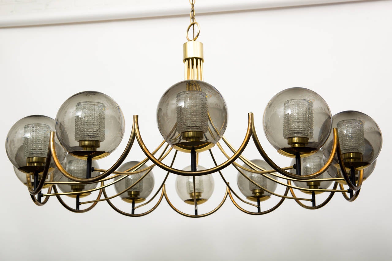 Large chandelier composed of 12 smoky glass globes with pressed glass diffusers.