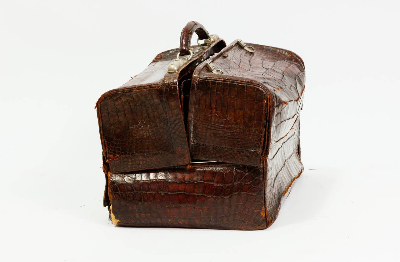 Made by Barrett and Sons, London. This vanity bag belonged to the owner of the Argentinian newspaper when Peron took over Argentina. Comes with pull out compartment and two smaller carrying cases. The bag has come apart in areas, needs restoration.