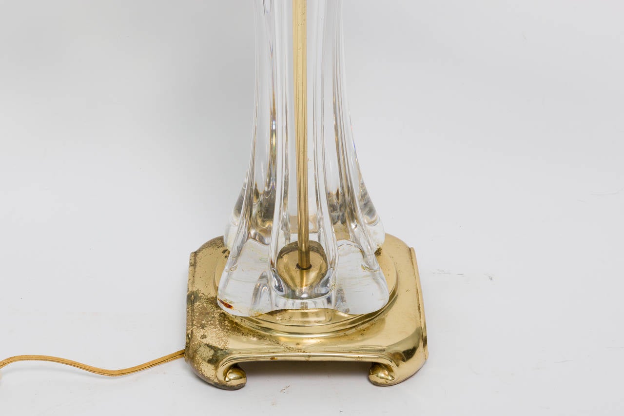 Brass plated metal and thick clear crystal table lamp from the 1970s.