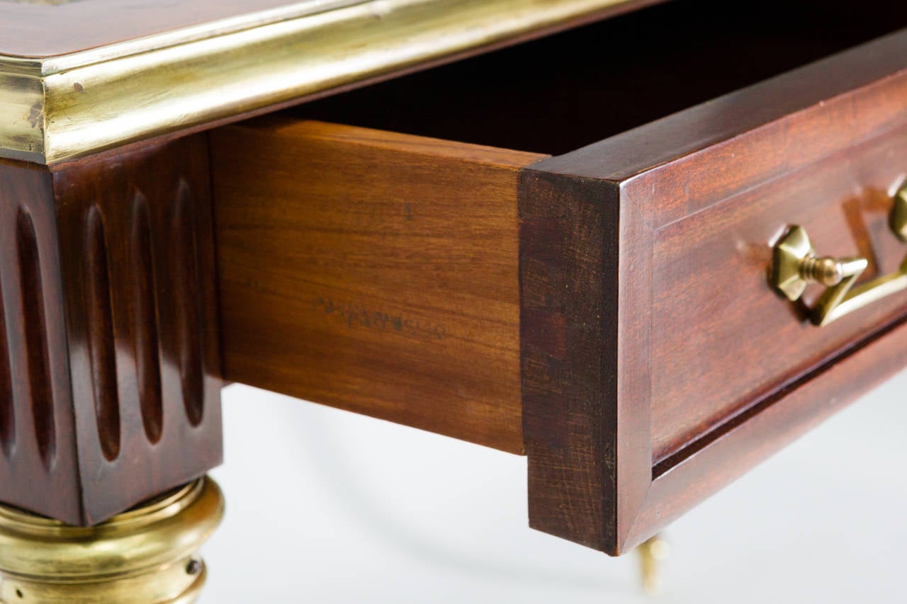 Leather top, fine brass accents. The back is finished in a faux partners desk style.