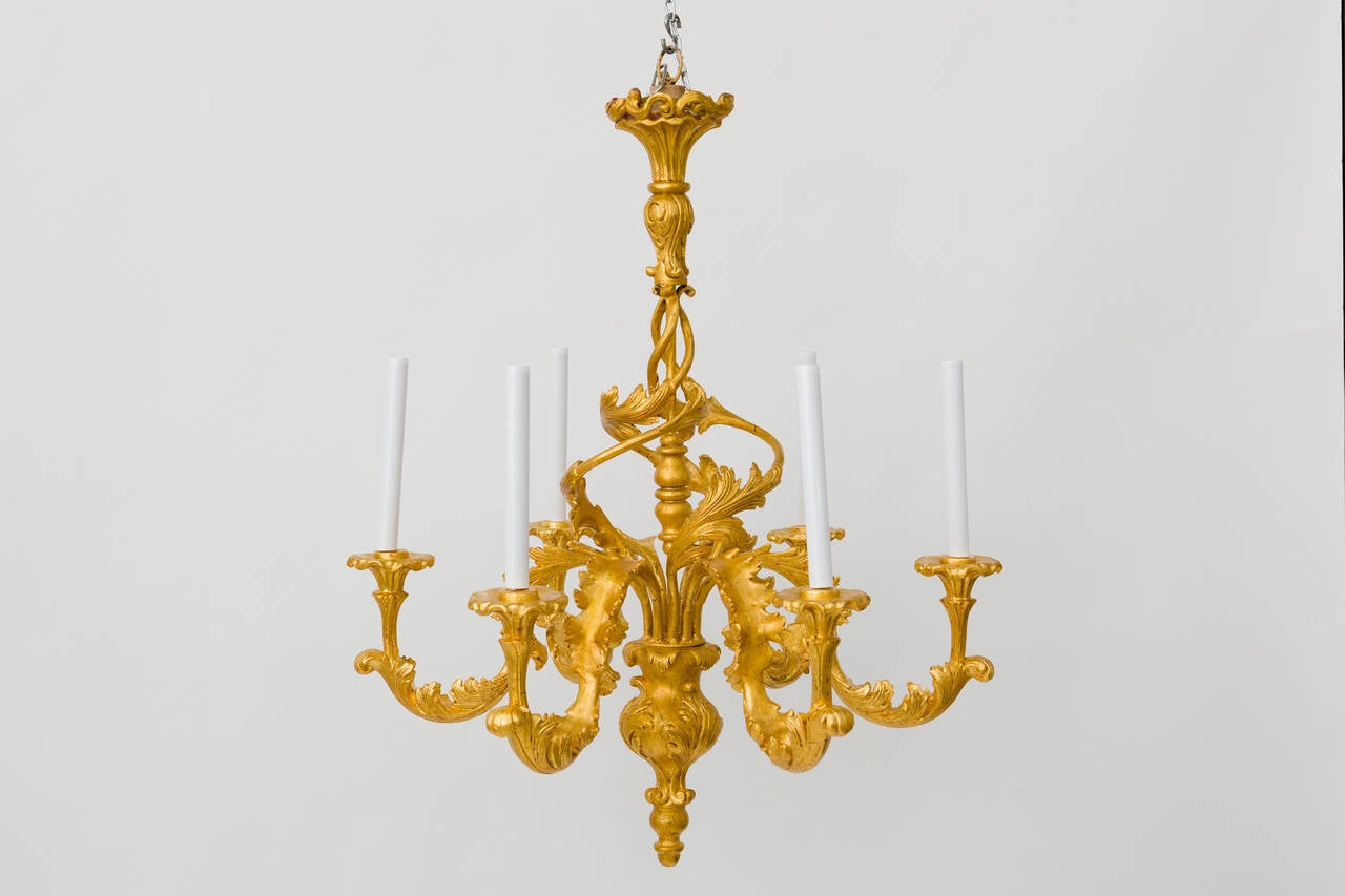 Stylish six-arm wood and metal chandelier.
Professionally restored with 22 karat gold leaf, new wiring and sockets.
Measures: 33