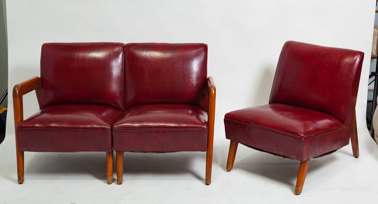 Great angles to this three-piece 1940s vinyl couch. Can be used as a full couch or a settee and side chair.