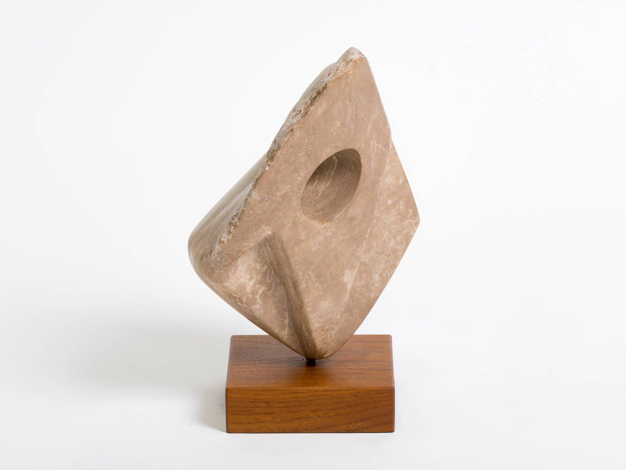 Marble abstract sculpture on wooden base.