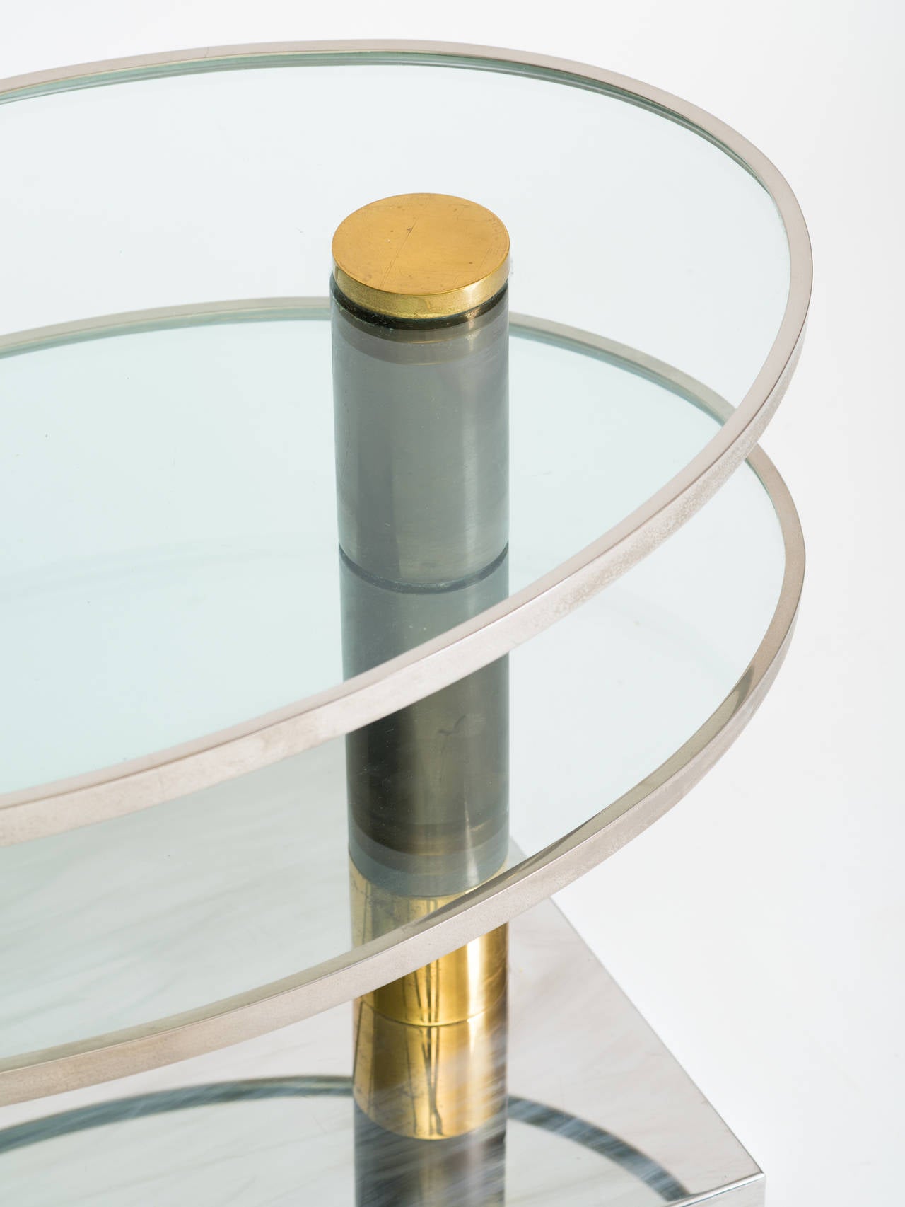 Pace two-tier revolving chrome and brass table. Scuff marks on base.