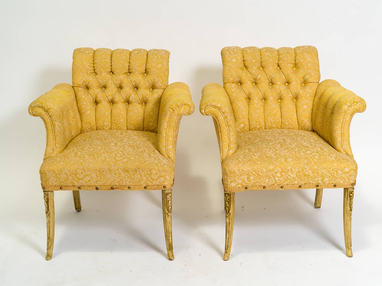 Beautiful pair of 1940s Hollywood Regency style tufted lounge chairs.