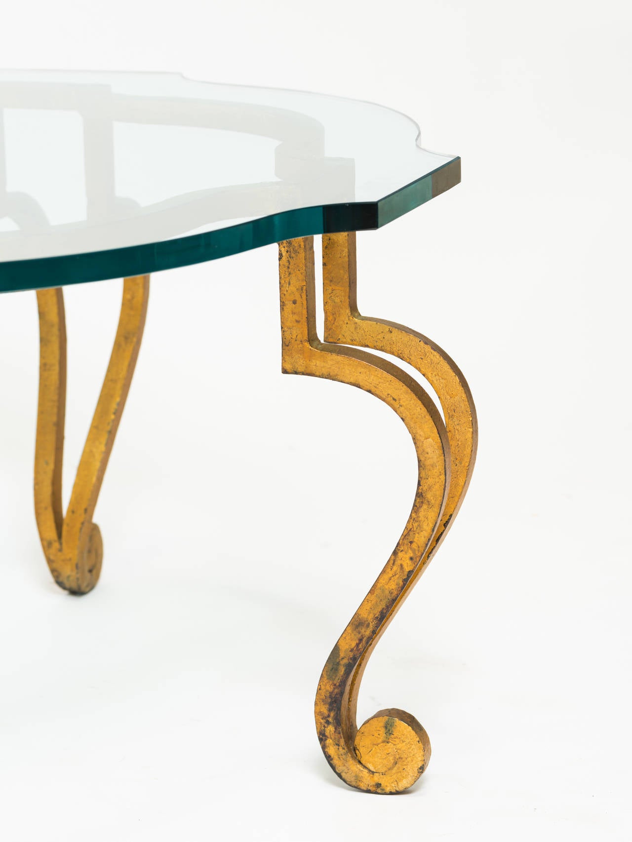 Italian gilt iron coffee table with scalloped glass top.