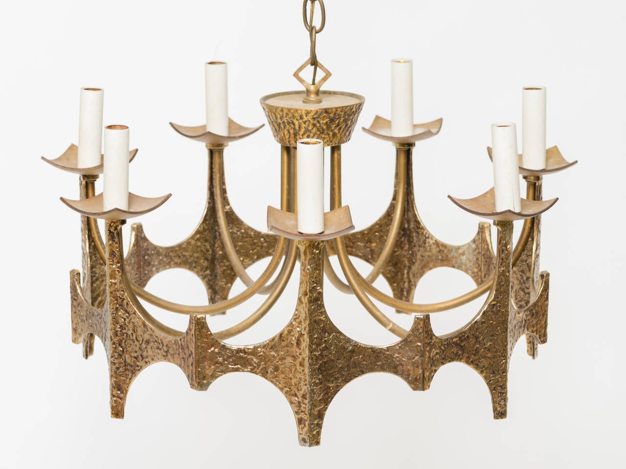Brutalist chandelier in textured hammered metal finish.