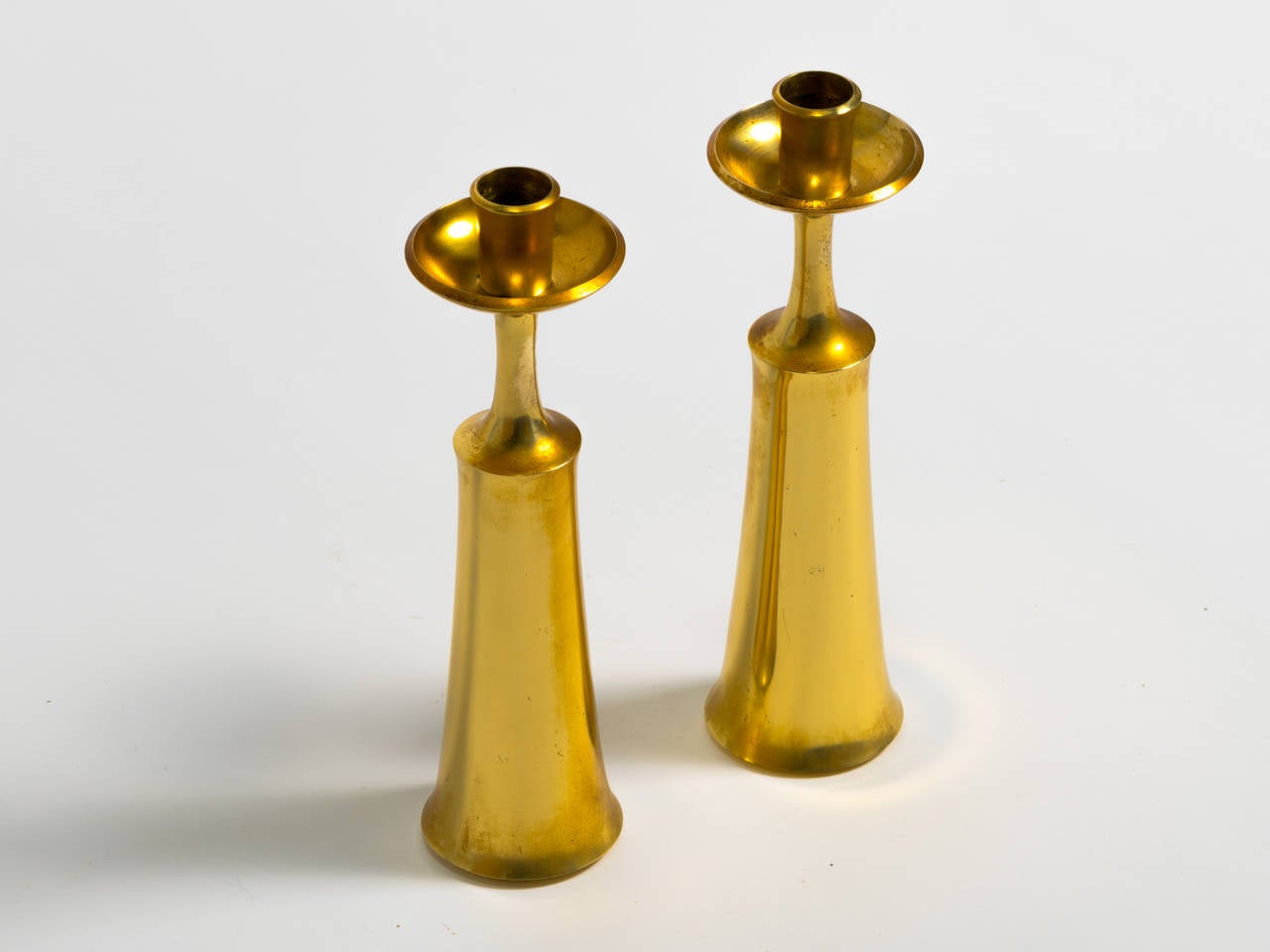 Pair of solid brass candlesticks, circa 1950. Measures: 9.25 inches high.