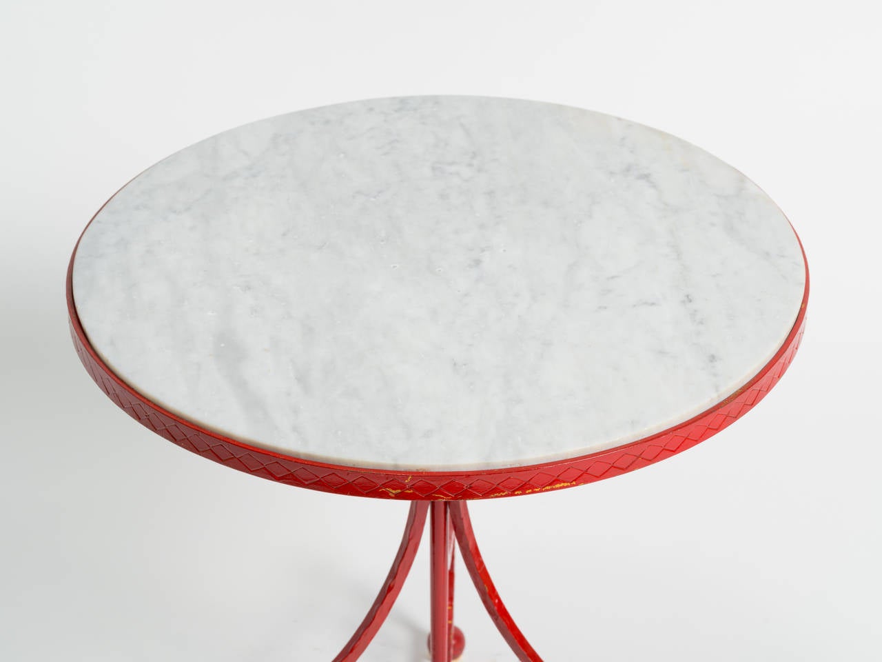 Originally gilded, a designer in the 1970s painted thisItalian  iron table red.
