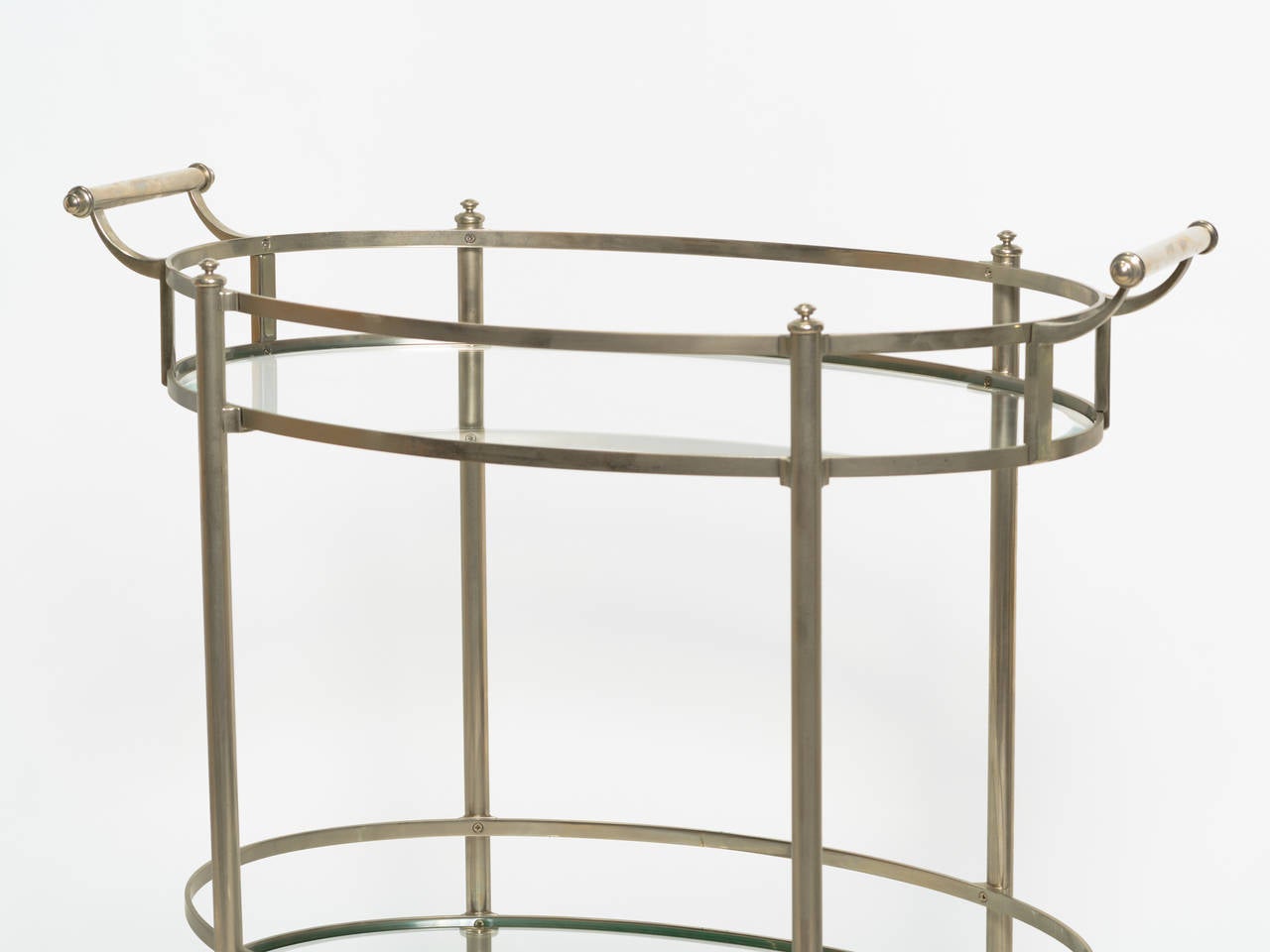 Mid century modern nickel plated serving cart with beveled edge glass shelves.