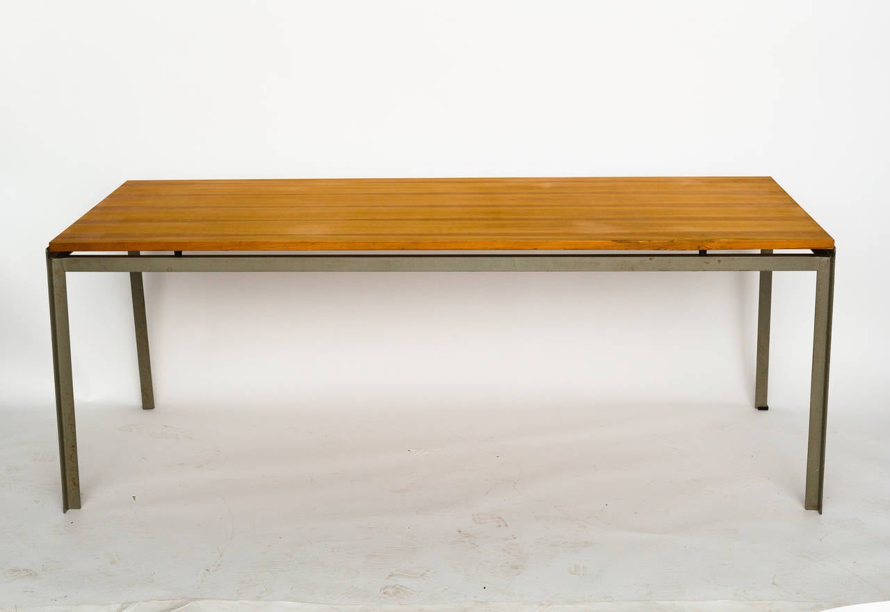 Mid-Century Danish modern worktable or writing table by Poul Kjaerholm. It has angled steel legs and a teak top.