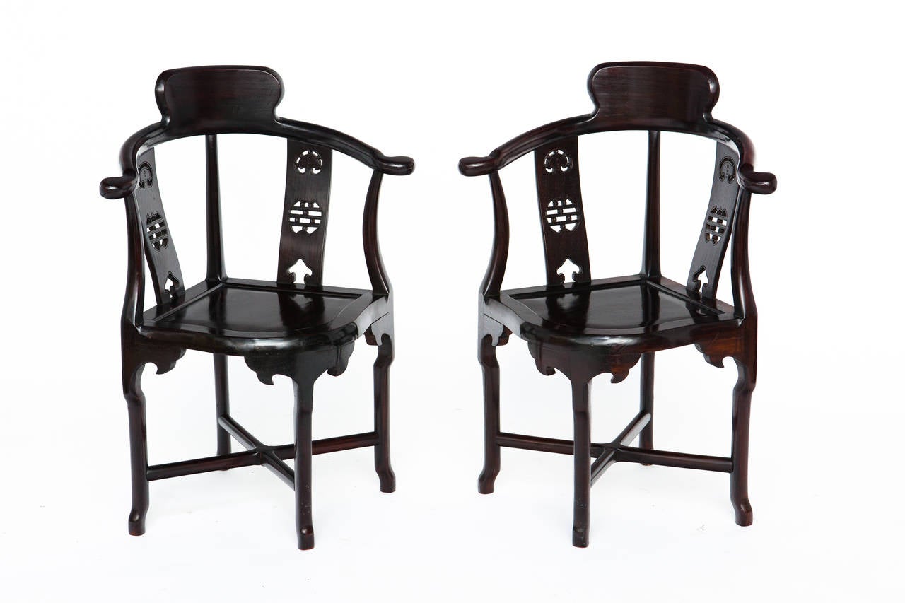 Pair of Chinese rosewood corner chairs. Signed Made in Hong Kong.