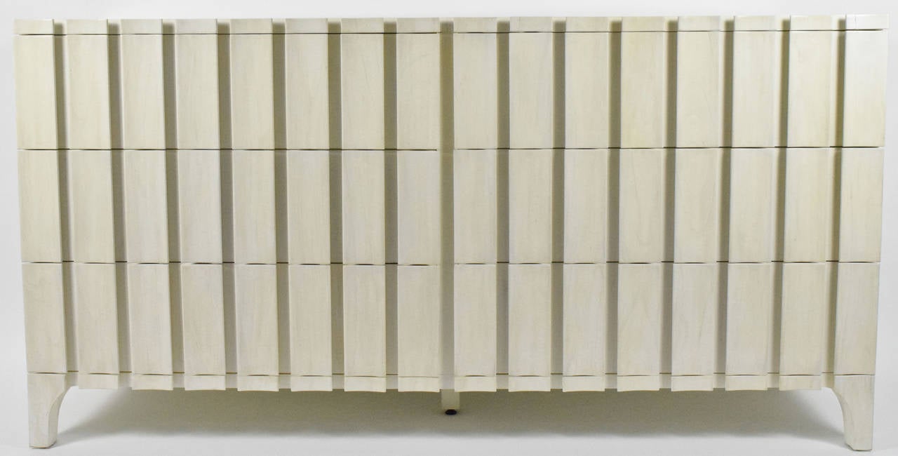 This is a beautiful sculptural dresser newly refinished in a white wash. There are six drawers and five legs.