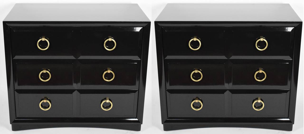 Pair of bachelors chests by John Widdicomb Furniture Company. They each have three drawers. Refinished in high gloss black lacquer, with the original labels still intact in the top drawer of each chest. Original solid brass ring pulls.