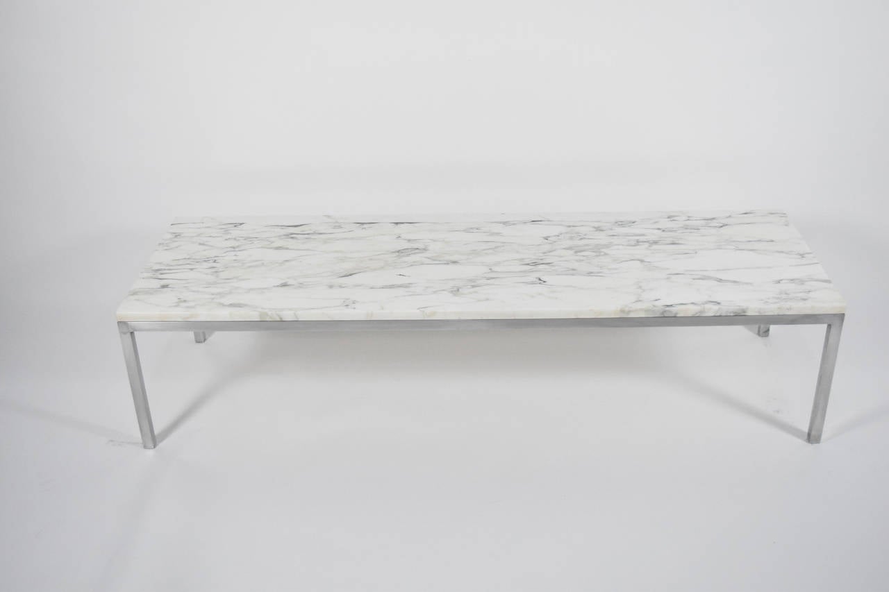 A beautiful marble top Florence Knoll coffee table with brushed metal base.