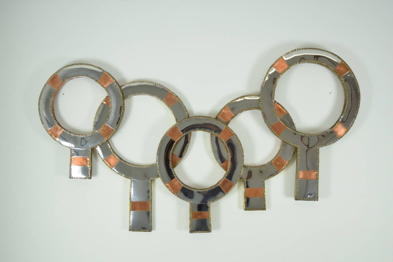 A unique metal wall sculpture with chrome and copper with brass rivets. Signed by Don Freedman, USA artist and textile artist.