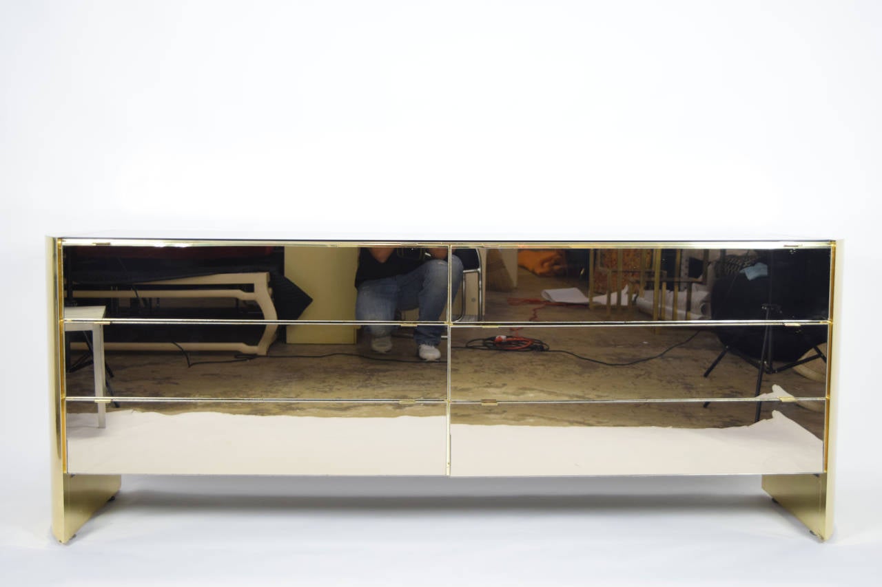 Beautiful smoked mirror and brass finish six-drawer dresser or cabinet by Ello. Cabinet has curved sides with a mirrored top and mirrored drawers.