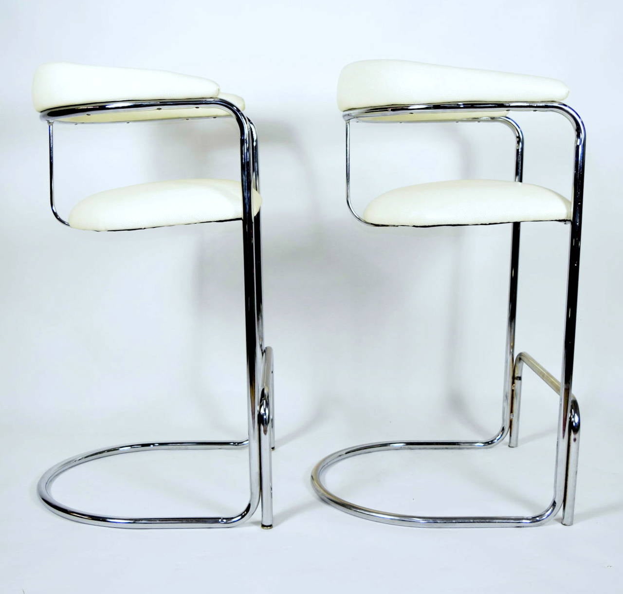 This is a great pair of barstools very much like Thonet and likely they are Thonet. They have been reupholstered in a Duralee snakeskin vinyl which is very durable. The chrome is in beautiful condition.
