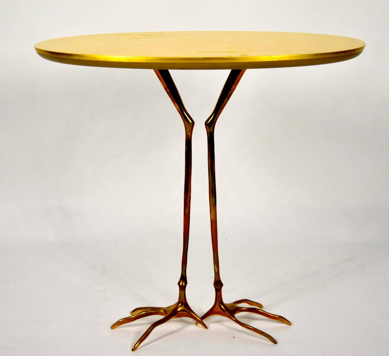 Beautiful gold leaf table with polished bronze base by Meret Oppenheim. In pristine condition.