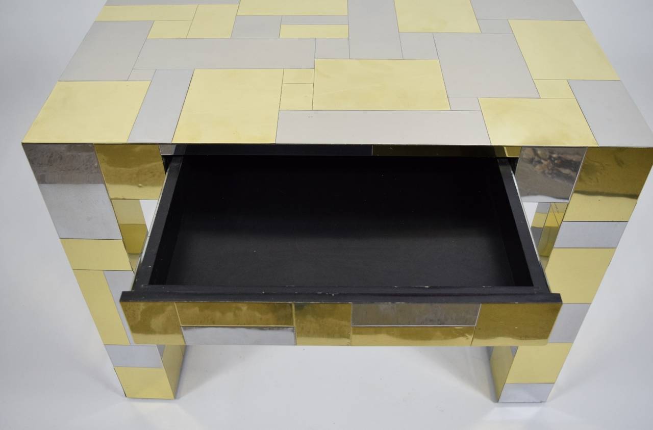 Paul Evans Cityscape side table in mixed patchwork of chromed steel and brass veneers. Side table with one drawer on a cantilevered base. This piece is signed "An Original by Paul Evans".
