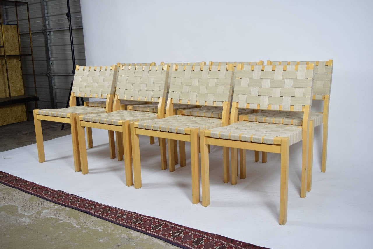 A set of eight Alvar Aalto 615 chairs with birch frames and flax webbing.